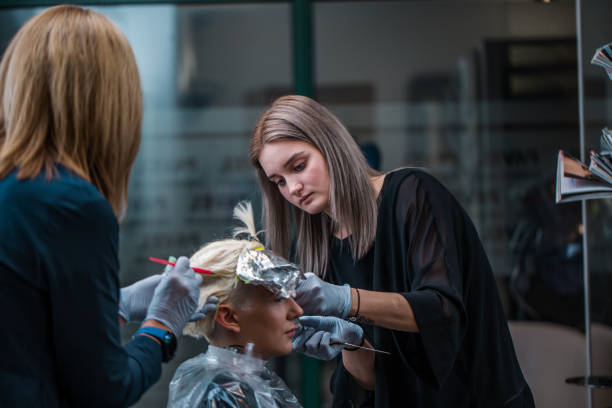 istock Two Hairdressers Working On The Same Customer 1251676847