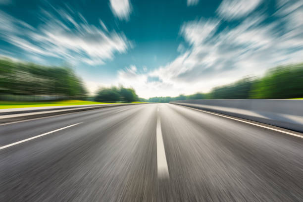 Fast moving road and green forest landscape. Fast moving asphalt road and green forest landscape. road stock pictures, royalty-free photos & images