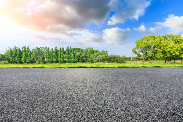 istock Asphalt road and green forest under blue sky. 1251679304