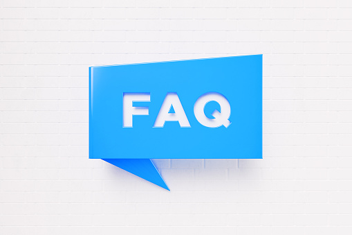 FAQ written blue chat bubble over white brick background. Horizontal composition with copy space. FAQ concept.