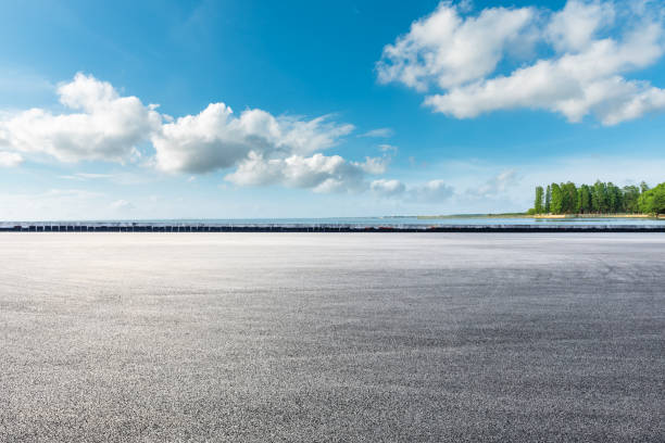 istock Asphalt road and lake under blue sky. 1251680158