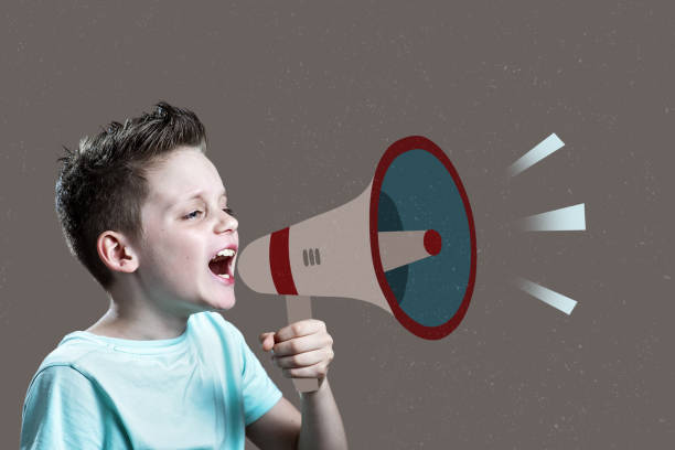 istock Boy shouting through vintage megaphone. Communication concept. 1251680258