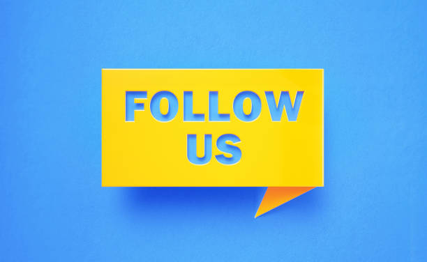 istock Follow Us Written Yellow Chat Bubble on Blue Background 1251681102