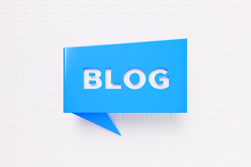 Blog written blue chat bubble over white brick background. Horizontal composition with copy space. Blog concept.