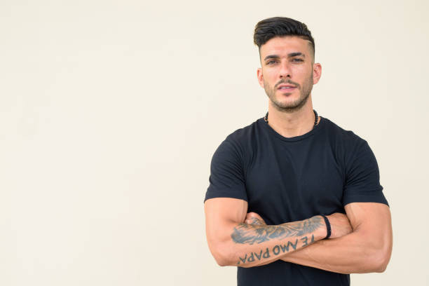 istock Young handsome bearded Persian man with arms crossed 1251683548