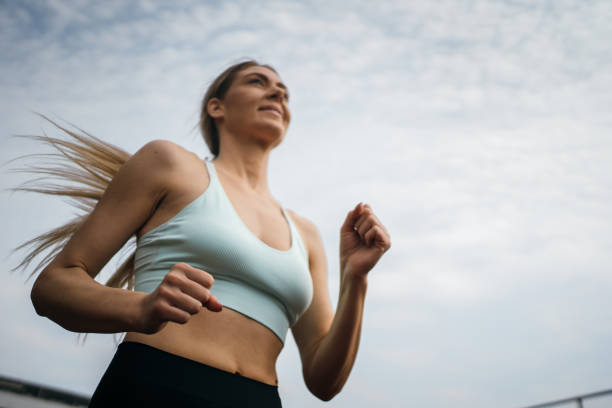 istock Smiling woman is jogging 1251683849