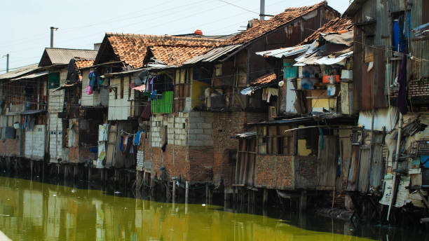 Slum area on the riverbank in Jakarta. Indonesia Slum area on the riverbank in Jakarta. Indonesia jakarta slums stock pictures, royalty-free photos & images