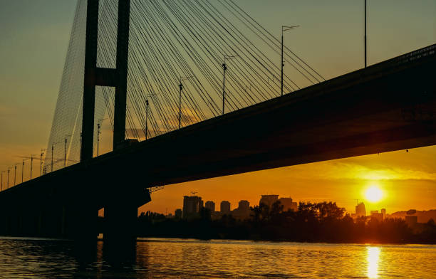 istock Bridge. Transport bridge on a background of sunset sun. 1251688150