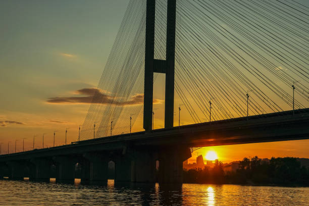 istock Bridge. Transport bridge on a background of sunset sun. 1251688169