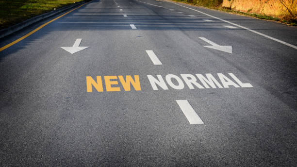 istock New normal word with white arrow on road 1251689006