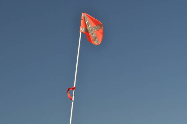 istock Orange reflective sand flag (mounted on four wheel drive vehicle) against blue sky in outback Australia. 1251692014