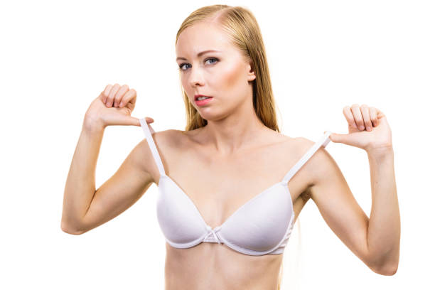 istock Young woman holding bra strap 1251693114