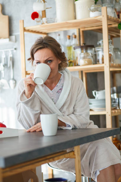 istock Mature woman sipping coffee and looking at camera 1251693192