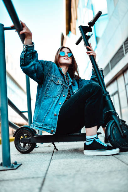 istock Female With Sunglasses Sitting On Electric Scooter 1251693514