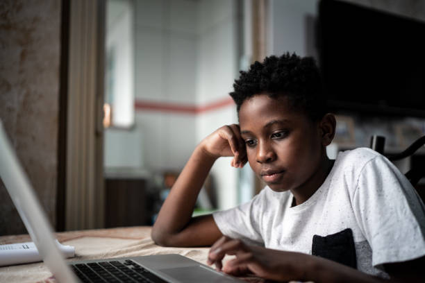 istock Child with laptop on a online class at home 1251696307