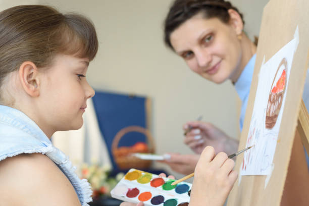 istock Teacher looks at how a student draws still life 1251706688