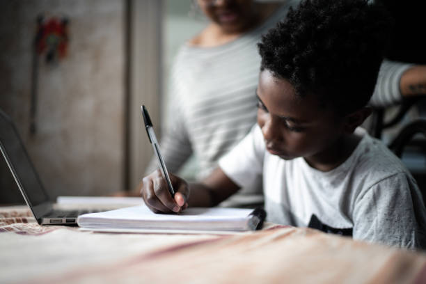 istock Mother helping son studying with laptop on a online class at home 1251706867