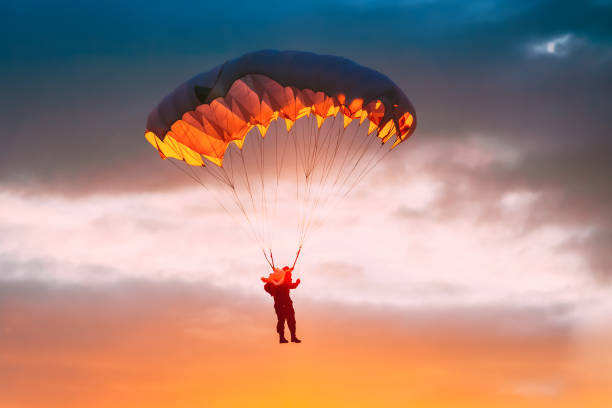 istock Skydiver On Colorful Parachute In Sunny Sky 1251706870