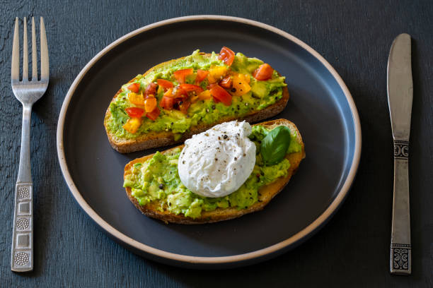 Tasty sandwich with poached egg and avocado