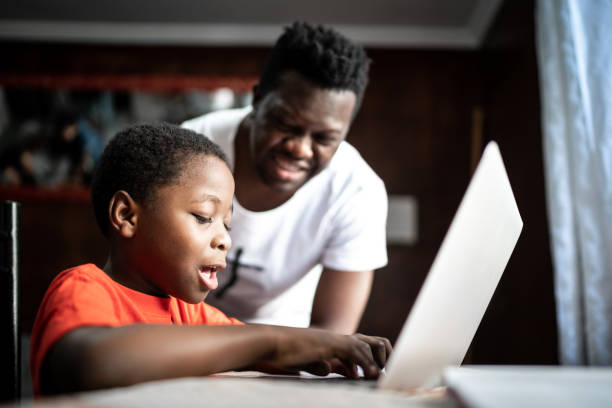 istock Father and son studying with laptop on a online class at home 1251712706