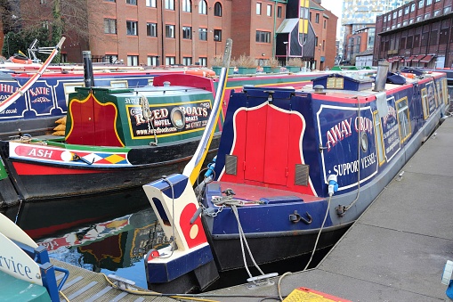 Narrowboats moored at Gas Street Basin in Birmingham, UK. Birmingham is the 2nd most populous British city. It has rich waterway and boat culture.