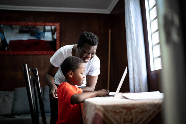 istock Father and son studying with laptop on a online class at home 1251715903