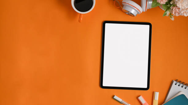 istock A colorful workspace is surrounding by white blank screen computer tablet and equipment. 1251716474