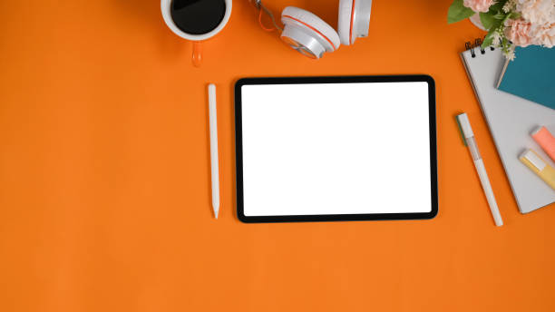 istock A colorful workspace is surrounding by white blank screen computer tablet and equipment. 1251716515