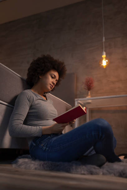 Woman reading a book at home
