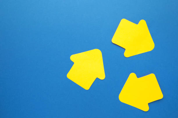 istock Paper sticky notes in shape of arrow on blue background 1251719247