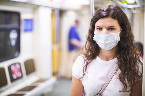 istock Young woman portrait in face protective mask in subway during quarantine 1251719944