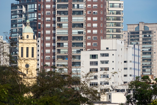 Tower of the church of Nossa Senhora do Carmo in front of residential buildings in the neighborhood of Aclimação in São Paulo