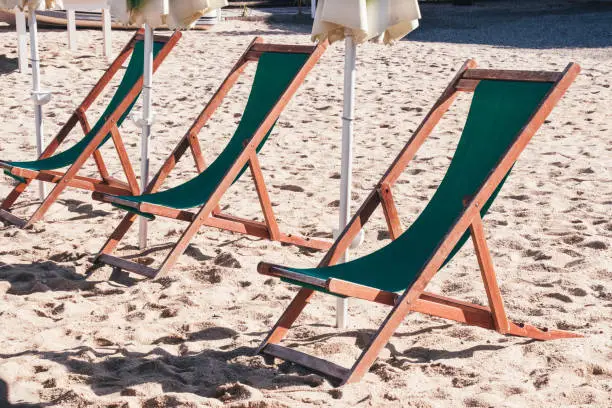 Vacation summer season 2020. Empty sunbeds on a beach. Summer vacation and Covid-19. Beach without people. Summer background.