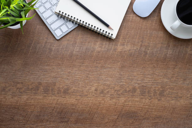 istock Wood office desk table with keyboard, notebook and coffee cup with equipment other office supplies. Business and finance concept. Flat lay with blank copy space, top view. 1251721479