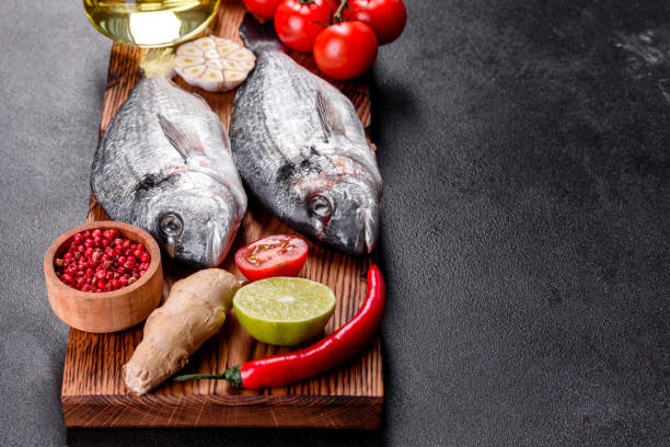istock Raw dorado fish with spices cooking on cutting board 1251721510