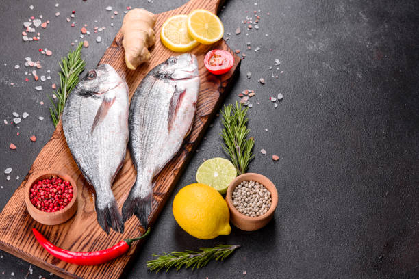 istock Raw dorado fish with spices cooking on cutting board 1251722041