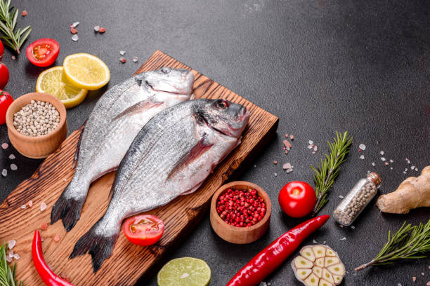 istock Raw dorado fish with spices cooking on cutting board 1251722309