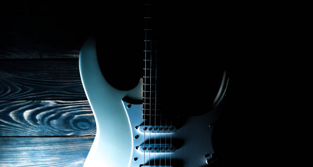 istock White electric guitar. Music concept. Creative style with light shadows. 1251722599