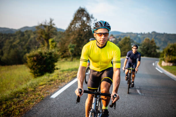 istock Young Men Enjoying Workout on Road Bikes in Countryside 1251723960