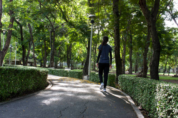 istock Young redheaded woman walking 1251724324