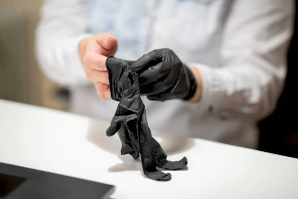 istock Putting on black protective gloves at the desk before using laptop 1251725490