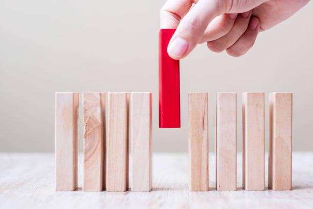 istock Businessman hand placing or pulling Red wooden block on table. Business planning, Risk Management, Solution, leader, strategy, different and Unique Concepts 1251725699