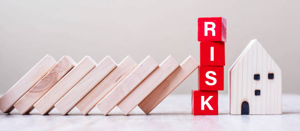 istock Red RISK cube blocks stop falling blocks protect house miniature. fall Business, Home Insurance, investment, Crisis, Economic recession, Developer, Real Estate and Property concept 1251725789
