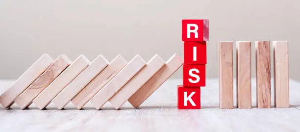 Photo of Red RISK cube blocks stop falling blocks on table. fall Business, planning, Management, Solution, Insurance and strategy Concepts