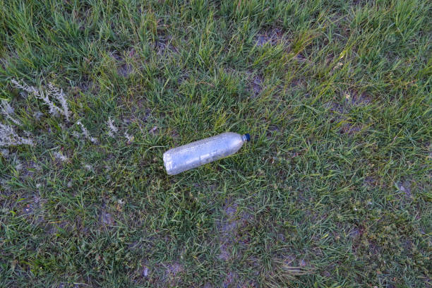 istock used plastic bottle as garbage on the grass, pollution concept 1251726789