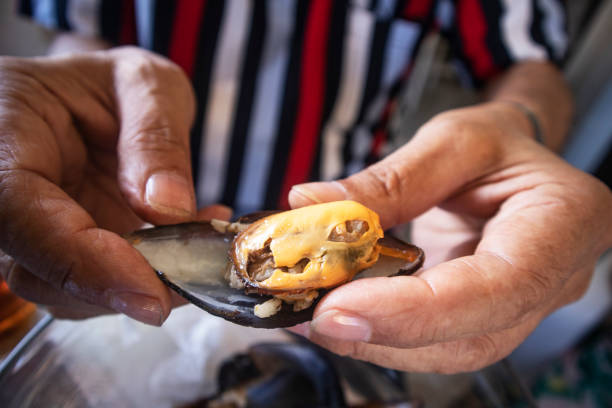 istock A man eating mussels 1251728112