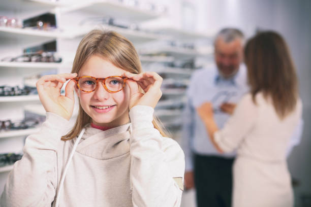 istock Girl trying on new eyeglasses 1251730111
