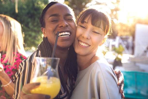 istock Happy group of multi ethnic friends enjoying drinks having fun together 1251730918