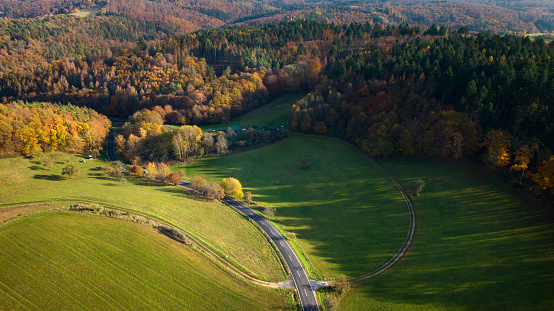 Aerial view of country road and autumnal landscape