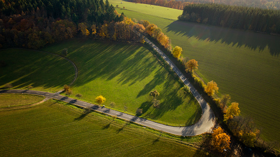 Aerial view of country road and autumnal landscape